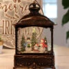11 Inch Decorative Bronze Water Lantern With Snow Family Sledding In Swirling Glitter -Solar Christmas Holiday Shop 2499030 snowmen main